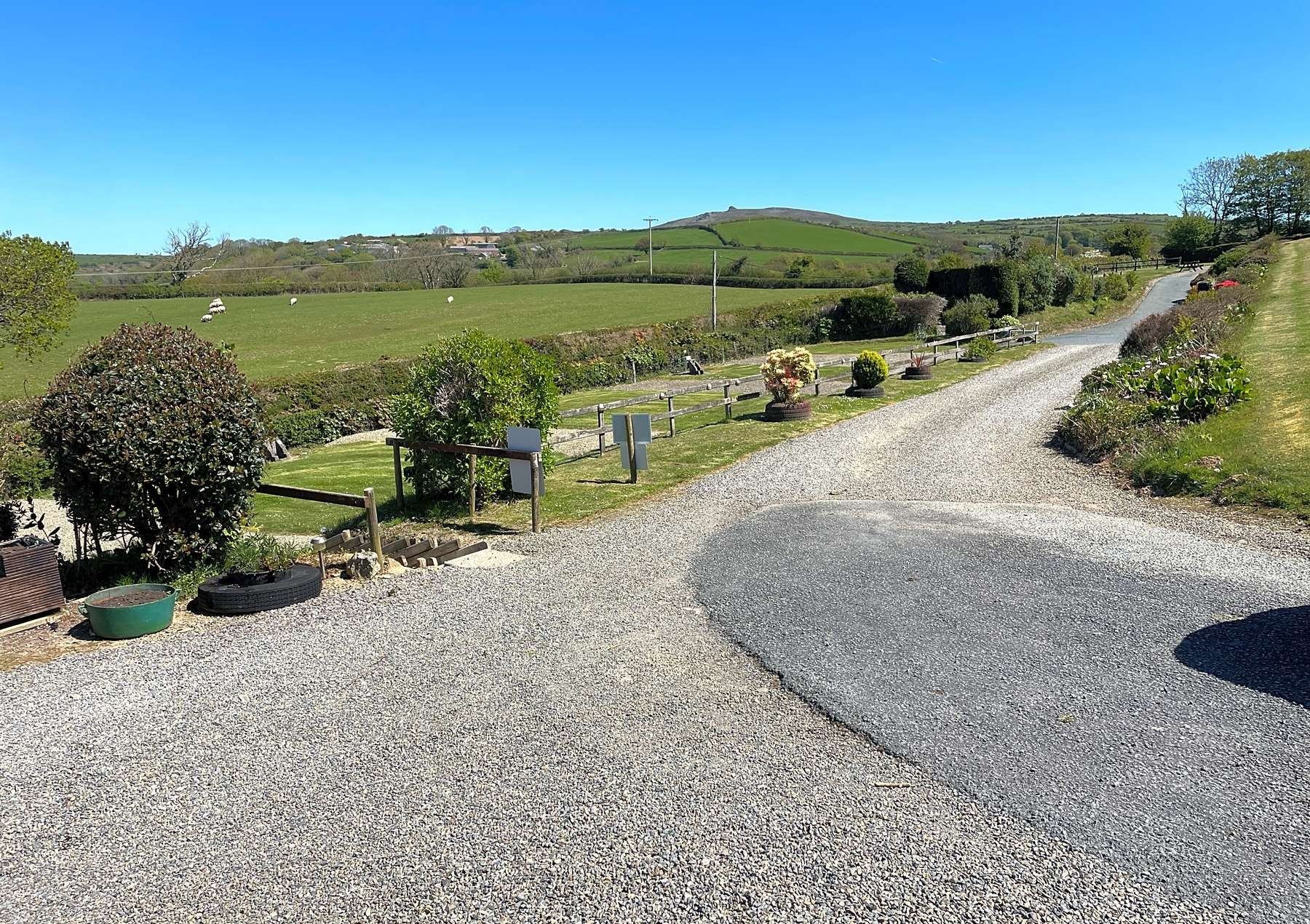 The sweeping drive into Gwaun Vale under a blue sky
