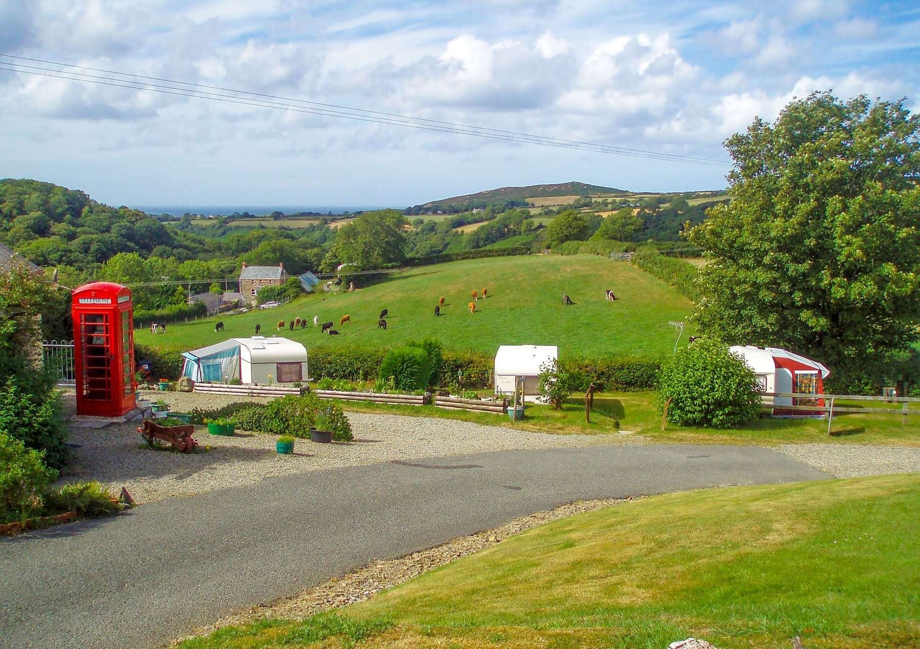 The red phone box beside caravans on their pitches at Gwaun Vale
